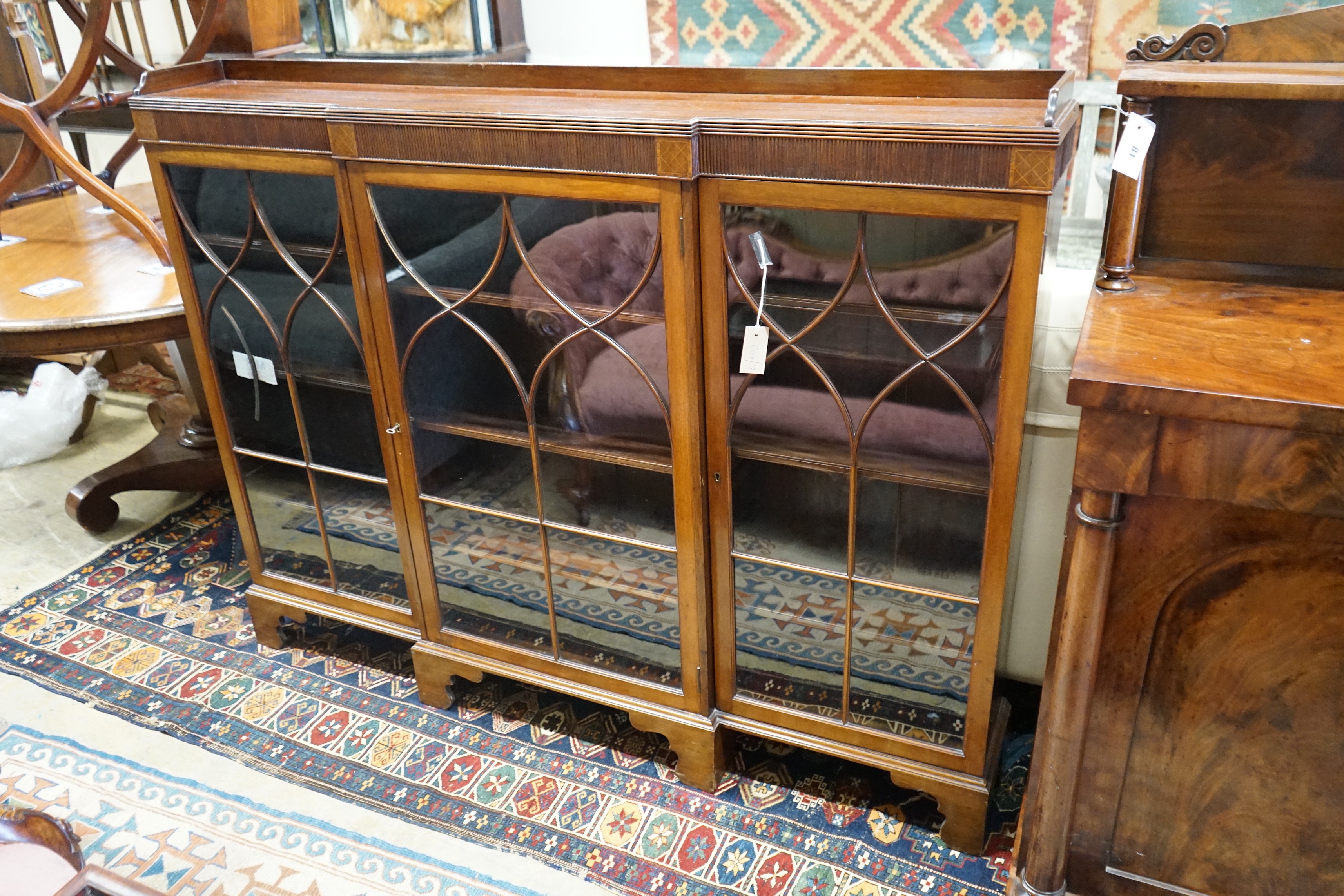 A 1920's Chippendale revival mahogany breakfront bookcase, length 154cm, depth 22cm, height 120cm